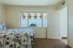 Windows with views of the ocean in second downstairs bedroom